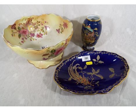 A Carlton Ware Bleu Royale vase, a Crown Devon Fielding's bowl and a large J. A. P. & S Carmen Ware pedestal bowl, with hand 