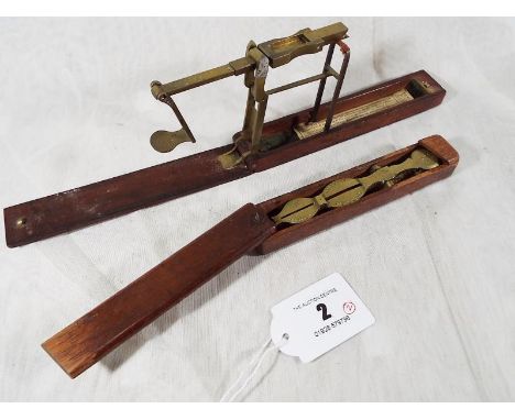 Two mahogany cased Sovereign and half-Sovereign scales, of which one with original paper label adhered within - Est £50 - £80