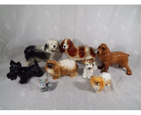 A collection of eight ceramic animals predominately different breeds of dogs (qty)