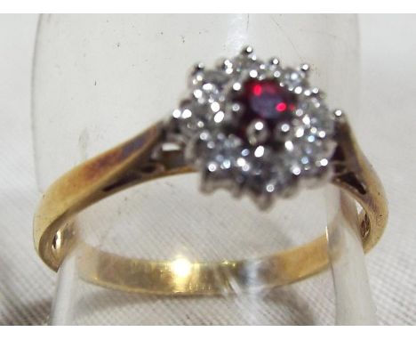 A lady's hallmarked 18ct yellow gold cluster ring, set with ruby and diamonds approximate diamond weight 40 points weight 3 g