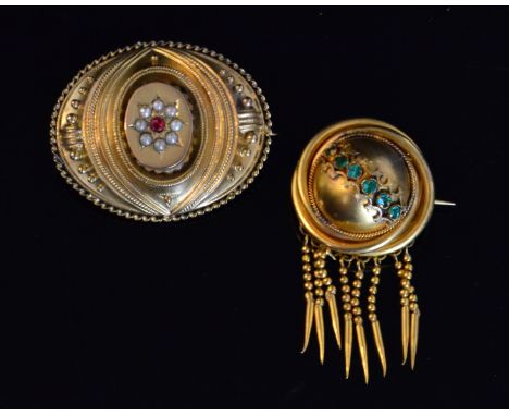 A Victorian 9ct Etruscan style brooch, the oval shaped brooch centred by a ruby and seed pearl set star with cast rope twist 