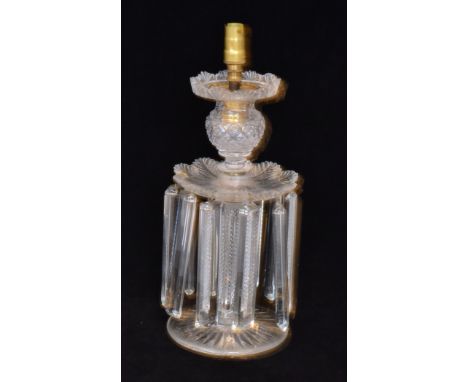 A 19th Century Wilkinsons clear crystal table lustre candlestick with a radial cut circular foot below a square column base w