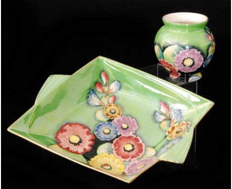A 1930s Carlton Ware Hollyhocks pattern 3973 diamond shaped dish with radiating fins, the central well decorated with enamel 