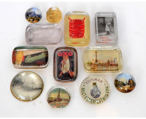 A collection of assorted glass paperweights incorporating advertising examples to include 'Ediswan' light bulbs, 'Ransomes' l