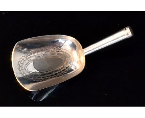 A George III hallmarked silver caddy spoon, spade bowl with bright cut engraved oval decoration below plain strut handle, len