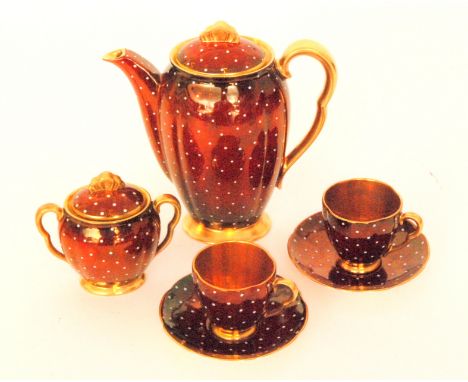 A 1930s Carlton Ware coffee pot, the rouge royale ground with white enamel polka dots, together with a matching sugar box and