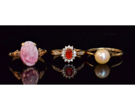 Three assorted 9ct stone set rings to include a fire opal and diamond cluster, a cultured pearl and a cameo example, various 