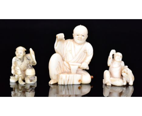 A late 19th to early 20th Century carved ivory netsuke in the form of a cook opening a basket to reveal a rat, height 3.5cm, 