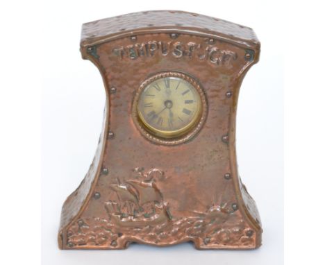 An early 20th Century 'Tempus Fugit' mantel clock in the Arts and Crafts style, the front decorated with a galleon in full sa