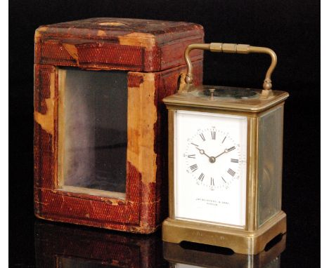 A 19th Century brass carriage clock with push button repeat the white enamelled dial by Jas Muirhead & Sons Glasgow in fitted