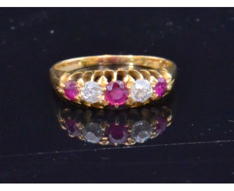 An early 20th Century 18ct ruby and diamond boat shaped ring, claw set alternating graduating stones, weight 2.5g, ring size 