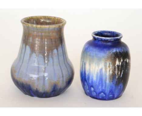 Two Ruskin Pottery vases, the first of globe and shaft form decorated in a streaked blue glaze, impressed marks and dated 192