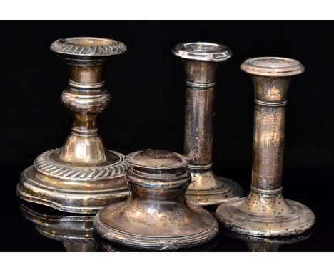 A pair of Edwardian hallmarked silver piano candlesticks of plain cylindrical form with reeded collar to conforming circular 
