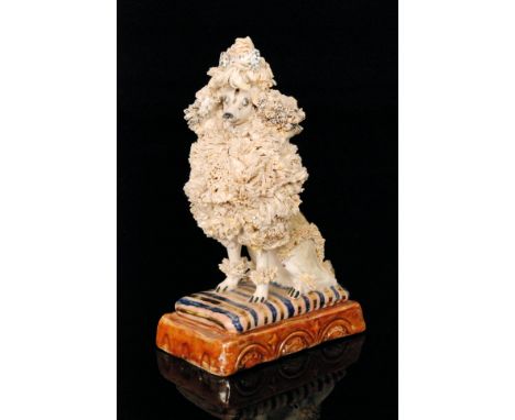 A Basil Matthews studio pottery model of a seated poodle entitled Nicole, signed to the base, height 16.5cm