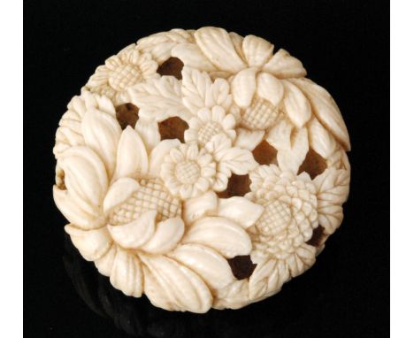 A late 19th to early 20th Century carved ivory netsuke in the form of a chrysanthemum flower head to one side and with multip