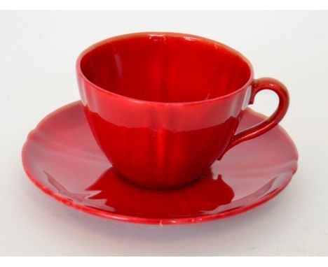 A Royal Doulton Flambe teacup and saucer decorated in a red glaze, printed marks, saucer diameter 9cm