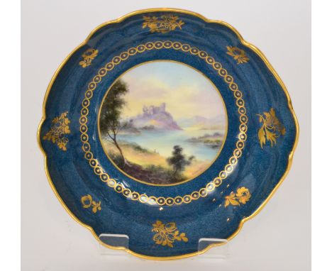 A Royal Worcester fluted dish decorated by G.H Evans with a hand painted central roundel of a Loch Scene with castle ruins in