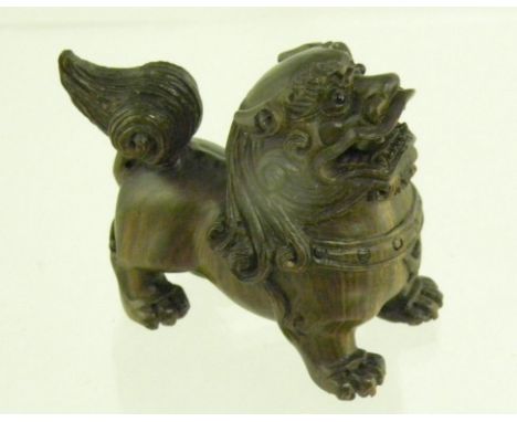A JAPANESE FINELY CARVED WOOD SHI SHI NETSUKE, SIGNED ON A MOTHER OF PEARL RESERVE