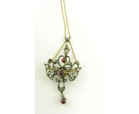 A RUBY AND DIAMOND BROOCH-PENDANT OF SCROLLING OPENWORK DESIGN ON INTEGRAL NECKLET, CIRCA 1900, 10.2G