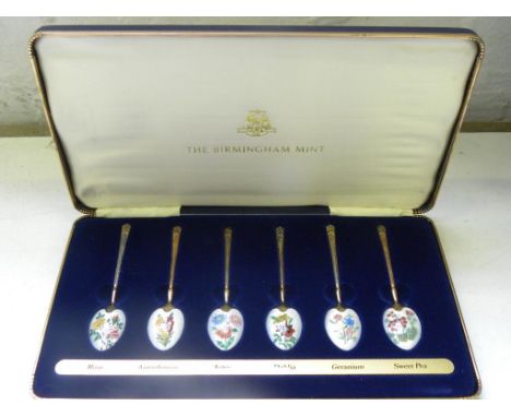 A SET OF SIX ELIZABETH II SILVER GILT AND ENAMEL COFFEE SPOONS, THE BOWLS WITH DIFFERENT FLOWERS, BY THE BIRMINGHAM MINT, BIR