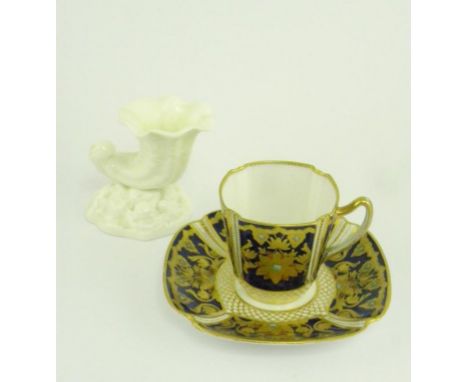 A COPELAND JEWELLED COBALT GROUND COFFEE CUP AND SAUCER AND A ROYAL WORCESTER GLAZED PORCELAIN SHELL SHAPED VASE