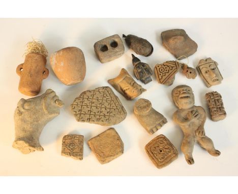 A collection of eighteen antiquities, including clay tile fragments, Mexican clay figures, a bell and a carved stone bird amu