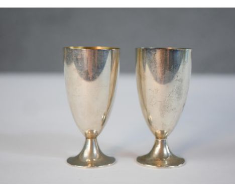 A pair of boxed Tiffany and Co sterling silver stemmed cordial glasses, gilded interiors and makers mark to base. Each with b