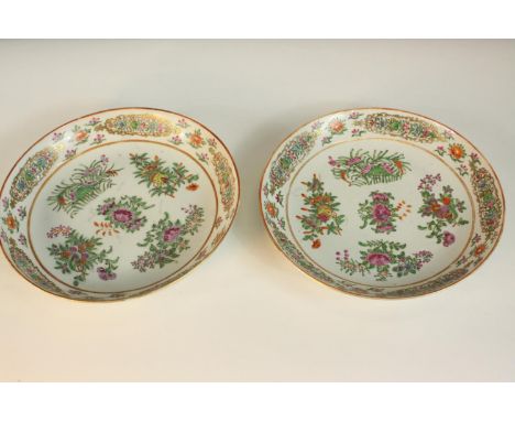 A pair of Chinese famille rose porcelain plates, decorated with flowers and with gilded detail. Dia.27cm (each). 