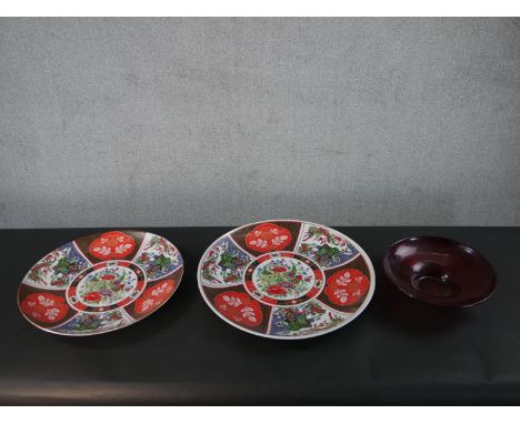 Two large transfer design Japanese chargers with sectioned floral design along with a vintage ruby art glass bowl. Diam.46cm 