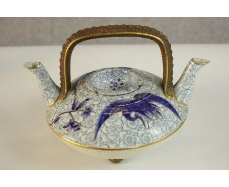 An Aesthetic movement 19th century Royal Worcester twin spout teapot with crane and foliate design on a floral print backgrou