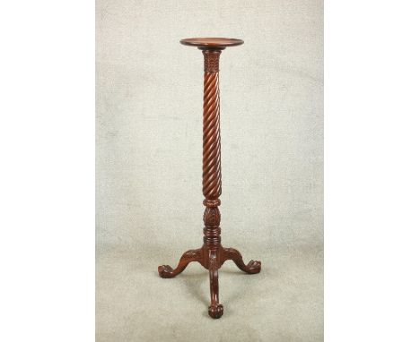 A Victorian style mahogany torchere, with a dished top on a wrythen column on tripod legs terminating in ball and claw feet. 