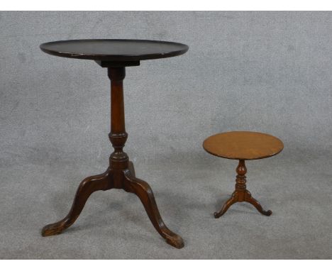 A 20th century George III style mahogany tripod table, with a circular top on a turned stem and tripod legs together with a s