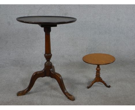 A 20th century George III style mahogany tripod table, with a circular top on a turned stem and tripod legs together with a s