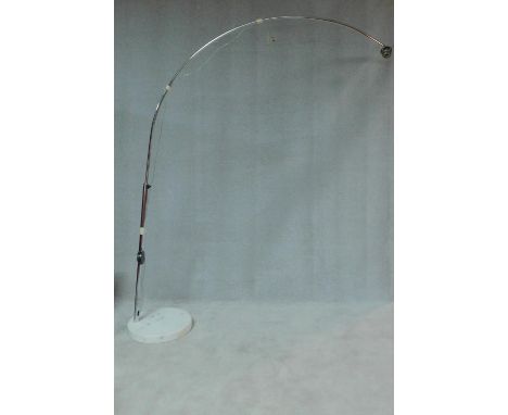 A chromium floor standing arc lamp on marble base, lacks shade. H.210 W.45 D.45cm 