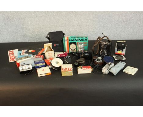 A collection of 35mm camera equipment and accessories. H.18 W.10 D.5cm. (largest) 