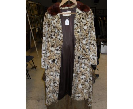 A mid 20th Century leopard fur coat with co-ordinating fur collar bears label "Harrisons Gloucester" (Cert No. 547704/01) CON