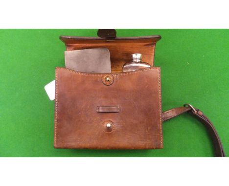A leather saddle lunch box containing a James Dixon & Sons pewter sandwich box and a glass flask with plated mounts