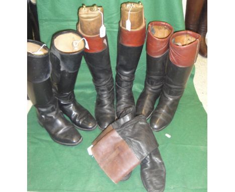 A pair of black and tan hunting boots with wooden trees and brass fittings together with two further pairs of black and tan h