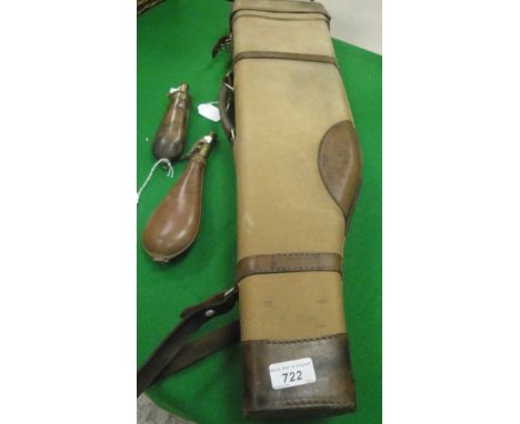 A leather mounted canvas convered Leg o Mutton gun case, a brass mounted leather shot flask by 'E. Steggles' and a copper and