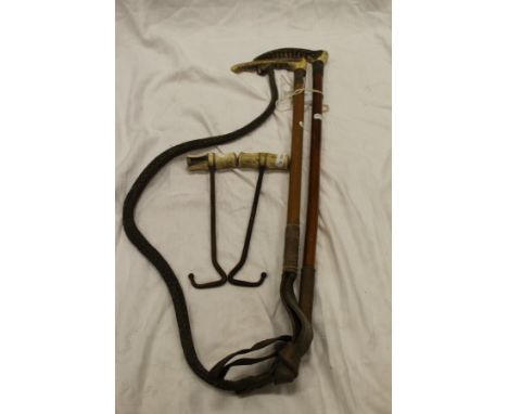 Two antler handled riding crops, and two bone handled boot pulls