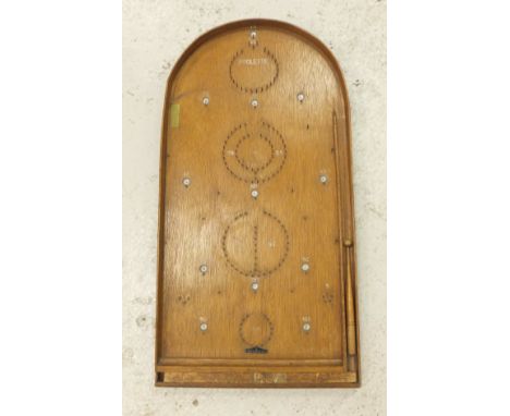 A Poolette bagatelle board in oak with pusher and sliding department with twelve balls