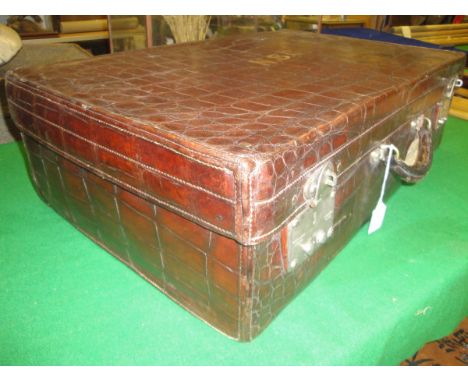 An early 20th Century Finigan Louis Vuitton style crocodile skin covered suitcase, the locks marked "Louis Vuitton 149 New Bo