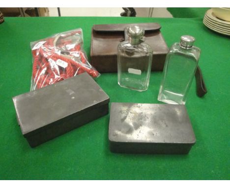 A leather saddle lunch box containing a James Dixon & Son sandwich tin and a silver mounted glass flask