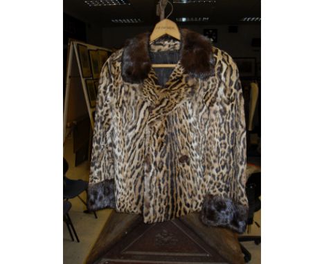 A mid 20th Century leopard jacket with mink collar inscribed "M. R. B." to the interior together with a similar sleeveless ex