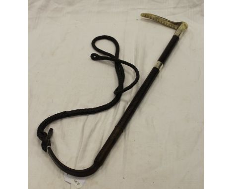 A hunting crop with antler handle and silver ferrule, plain and plaited leather shaft and thong, stamped silver