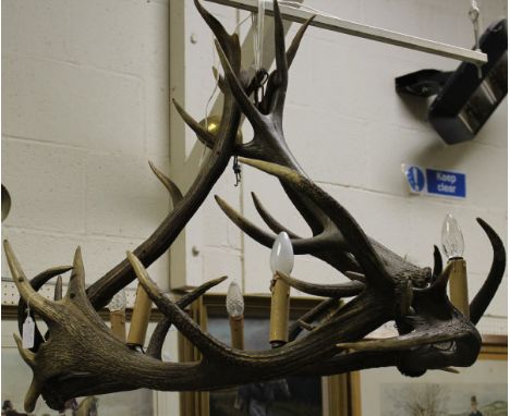 A red antler chandelier of circular form