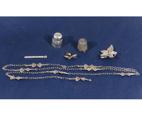 Two silver thimbles, three silver brooches and a decorative chain