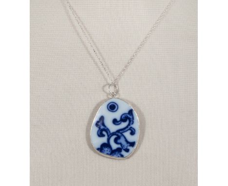 A Ming dynasty blue and white porcelain shard mounted in Chinese silver with sterling silver chain.