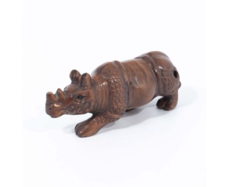 A hand carved hardwood netsuke of Sumatran rhinoceros