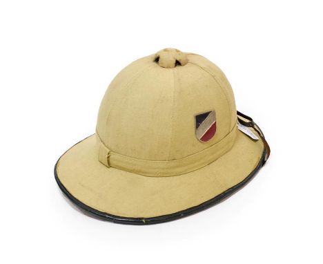 A German Third Reich 1940 Pattern Tropical Pith Helmet, of cork covered in light tan canvas, the skull with six panels and a 